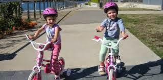 image of two kids on bicucles children's bikes